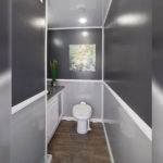 image displays the interior of a luxury portable restroom trailer